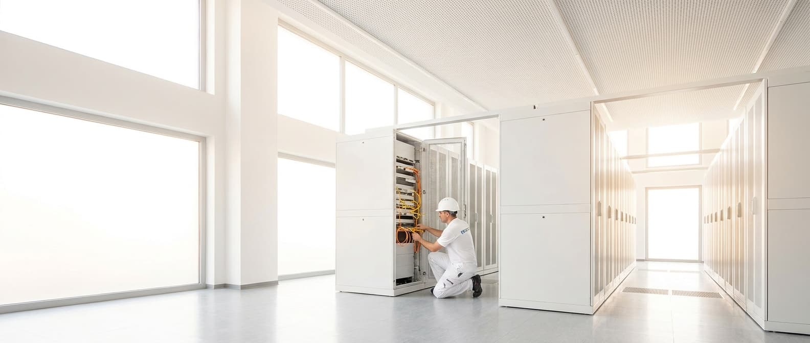 13 Wires technician installing fiber optic cabling in a data center